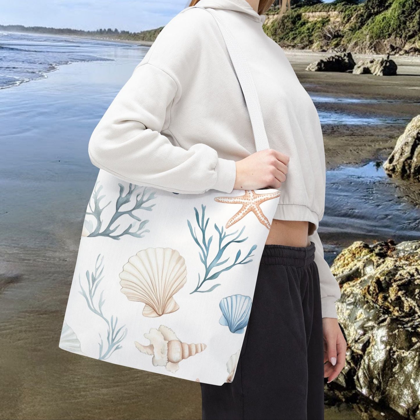 16" x 16" White tote bag with pastel blue and coral seashells, starfish, and underwater plants, with white handles.