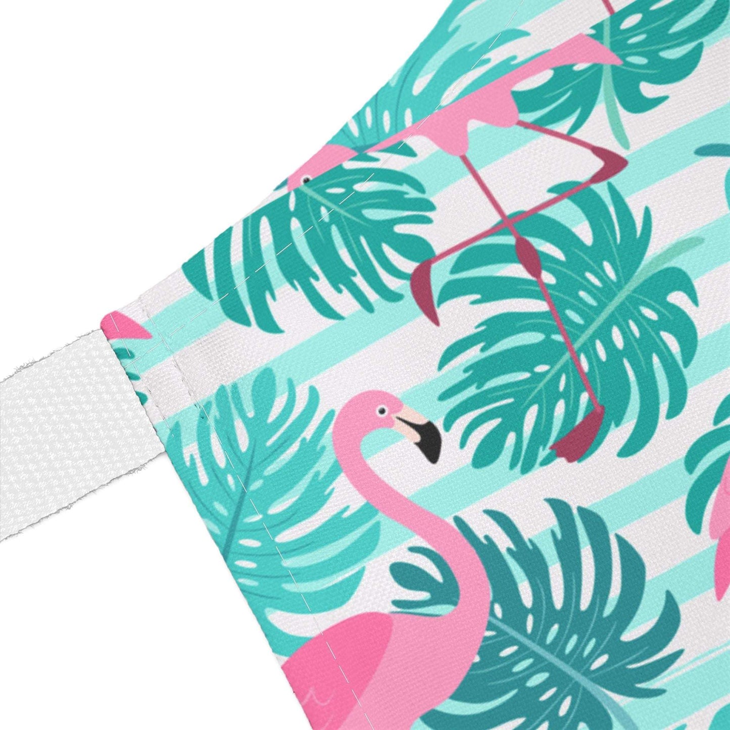 the close up of a Tropical Flamingo Apron in pink, white, and teal with a white strap.