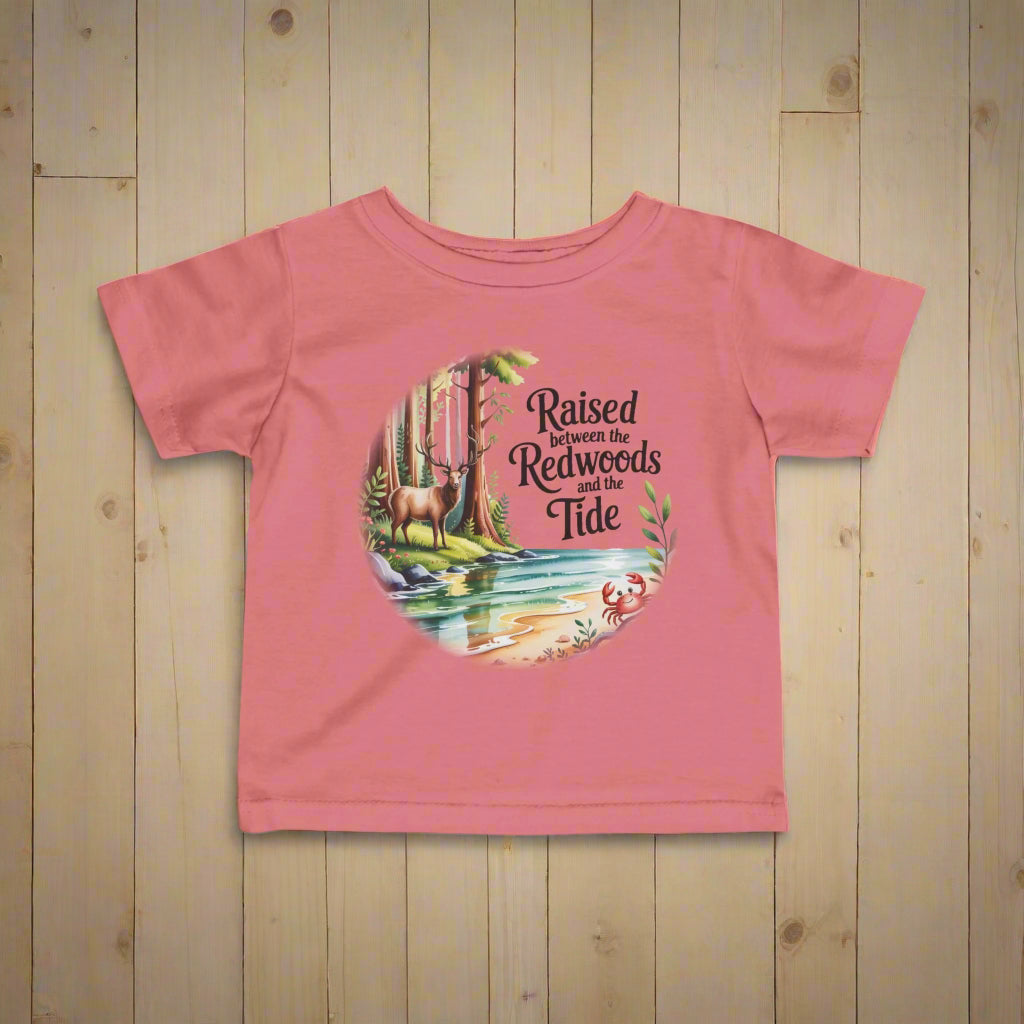 Pink t-shirt with nature-themed graphic and text on a white background