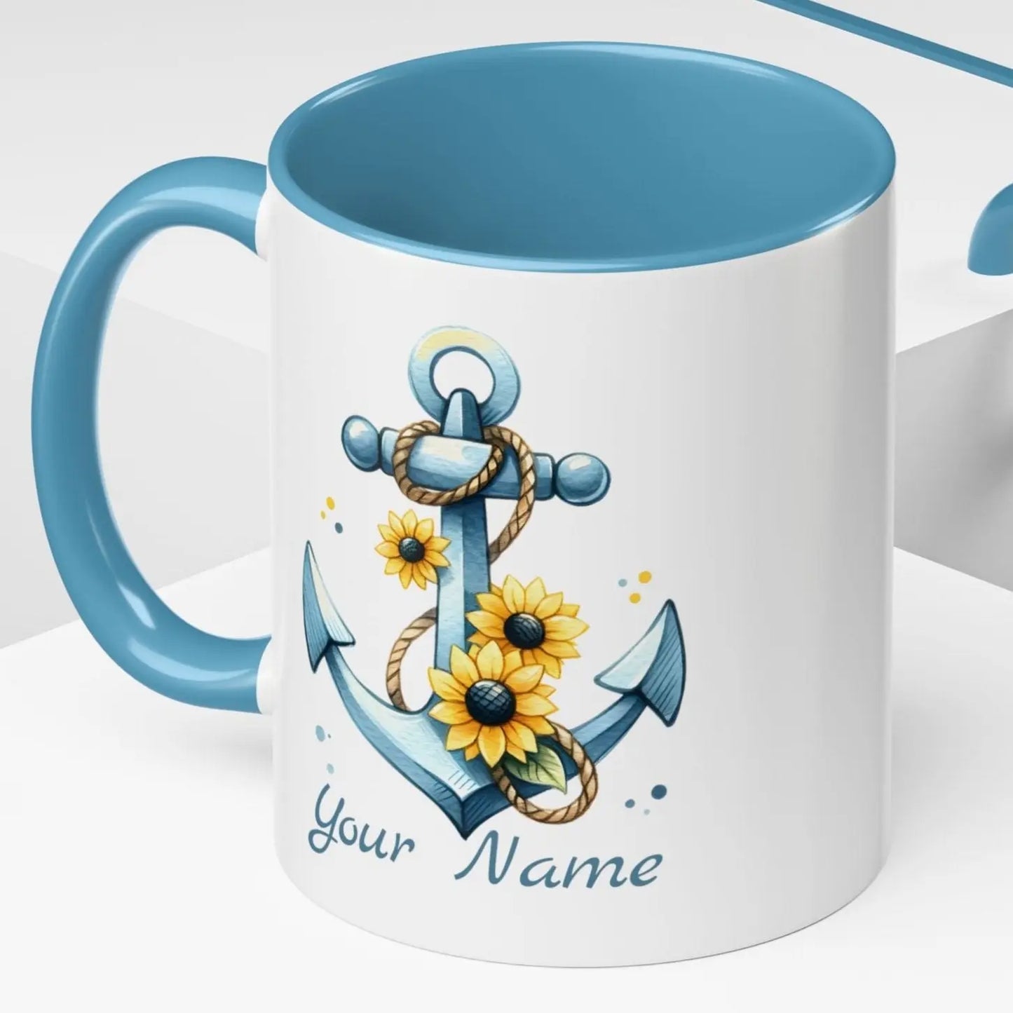 11 oz White mug with baby blue handle and interior with Anchor and Sunflowers with text Seas the Day