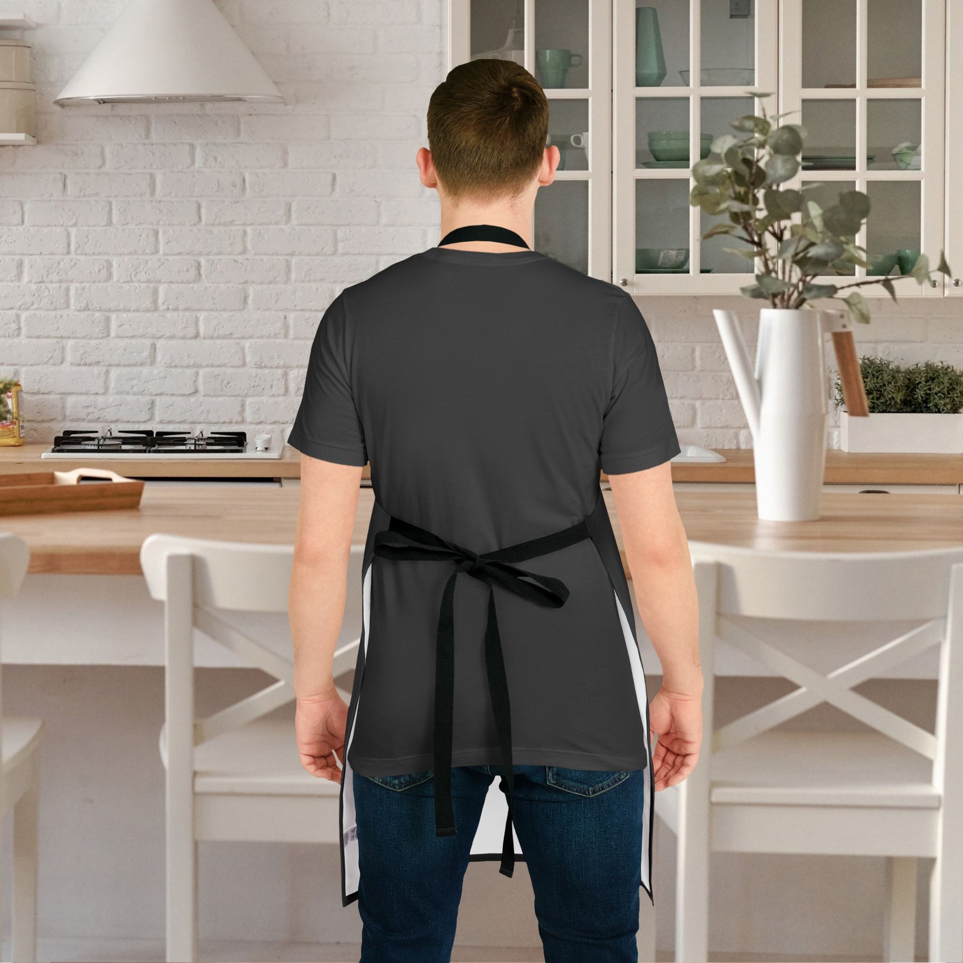 Person wearing a black apron in a kitchen setting