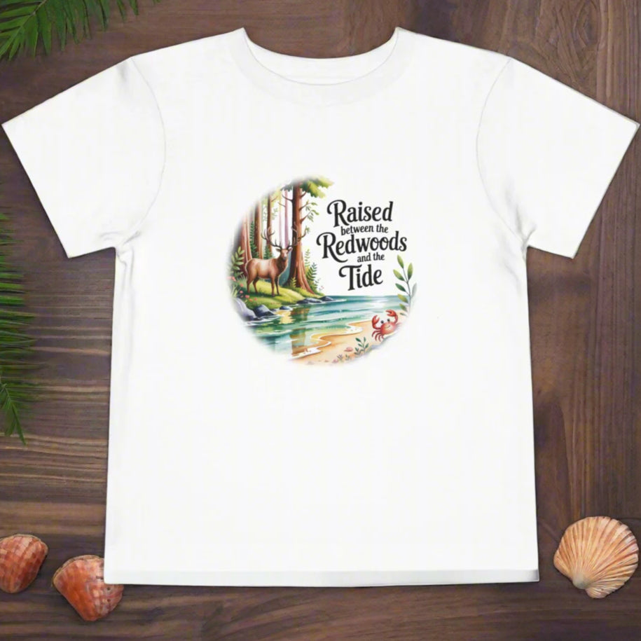 White t-shirt with a graphic design featuring trees and text on a white background