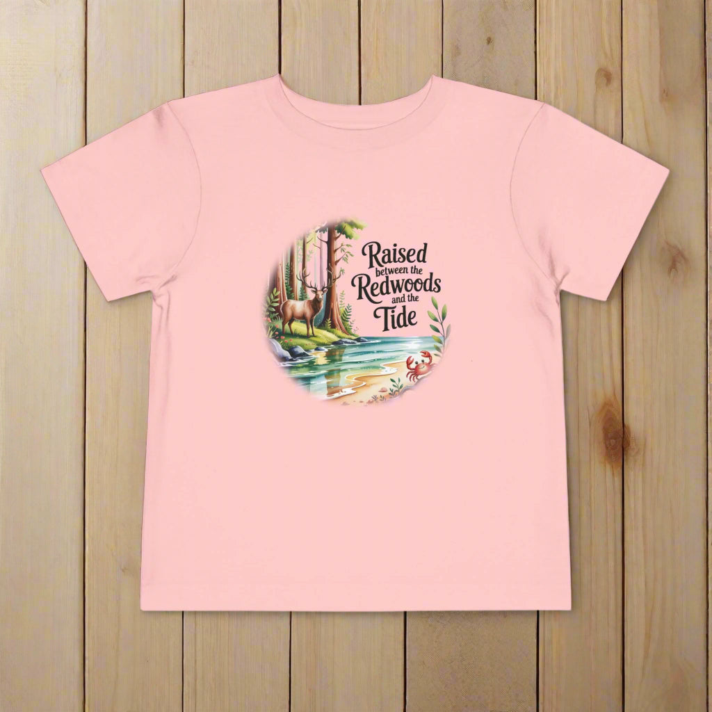 Pink t-shirt with nature-themed graphic and text on a white background