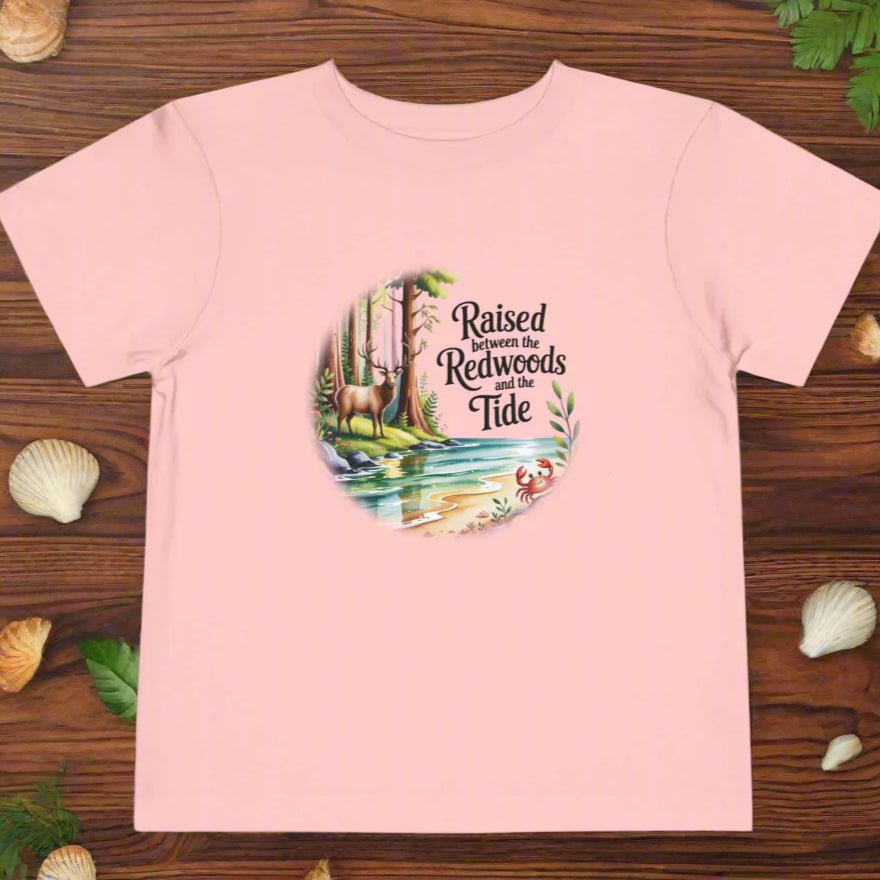Pink t-shirt with nature-themed graphic and text on a white background