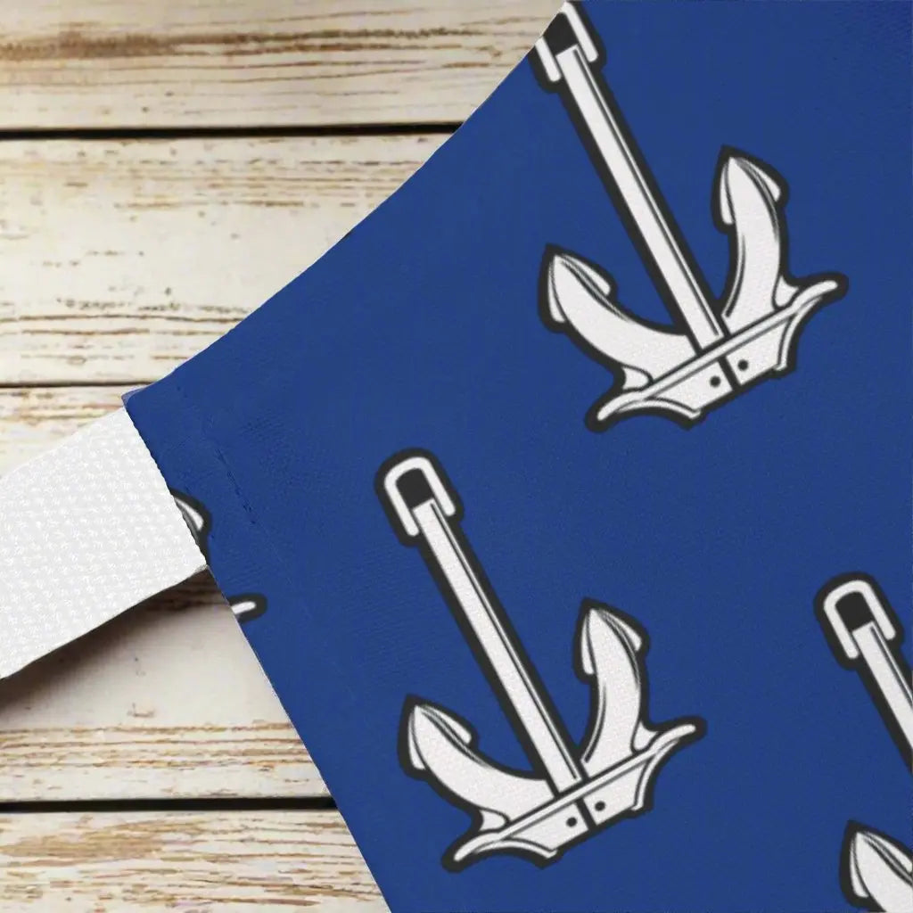 Close up of Blue Apron with white straps with white anchors and says Dad Anchored to the Grill with utensils in the font.