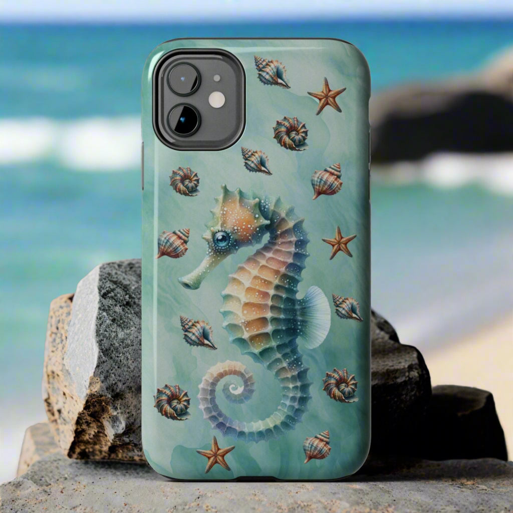 Phone case with seahorse and shell design on a green background