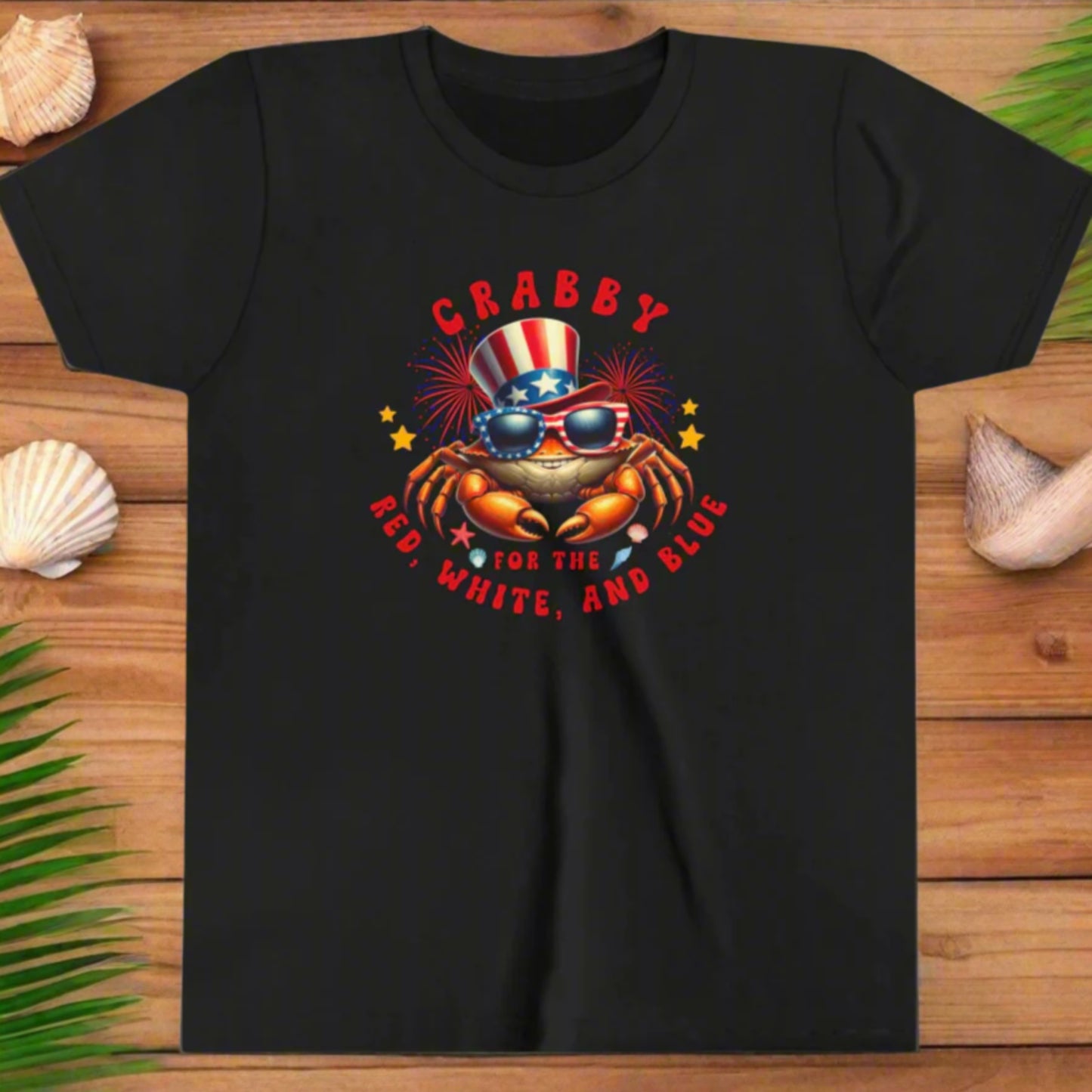 Black t-shirt with a crab wearing sunglasses and an American flag hat, text 'CRABBY FOR THE RED, WHITE, AND BLUE' on a white background.