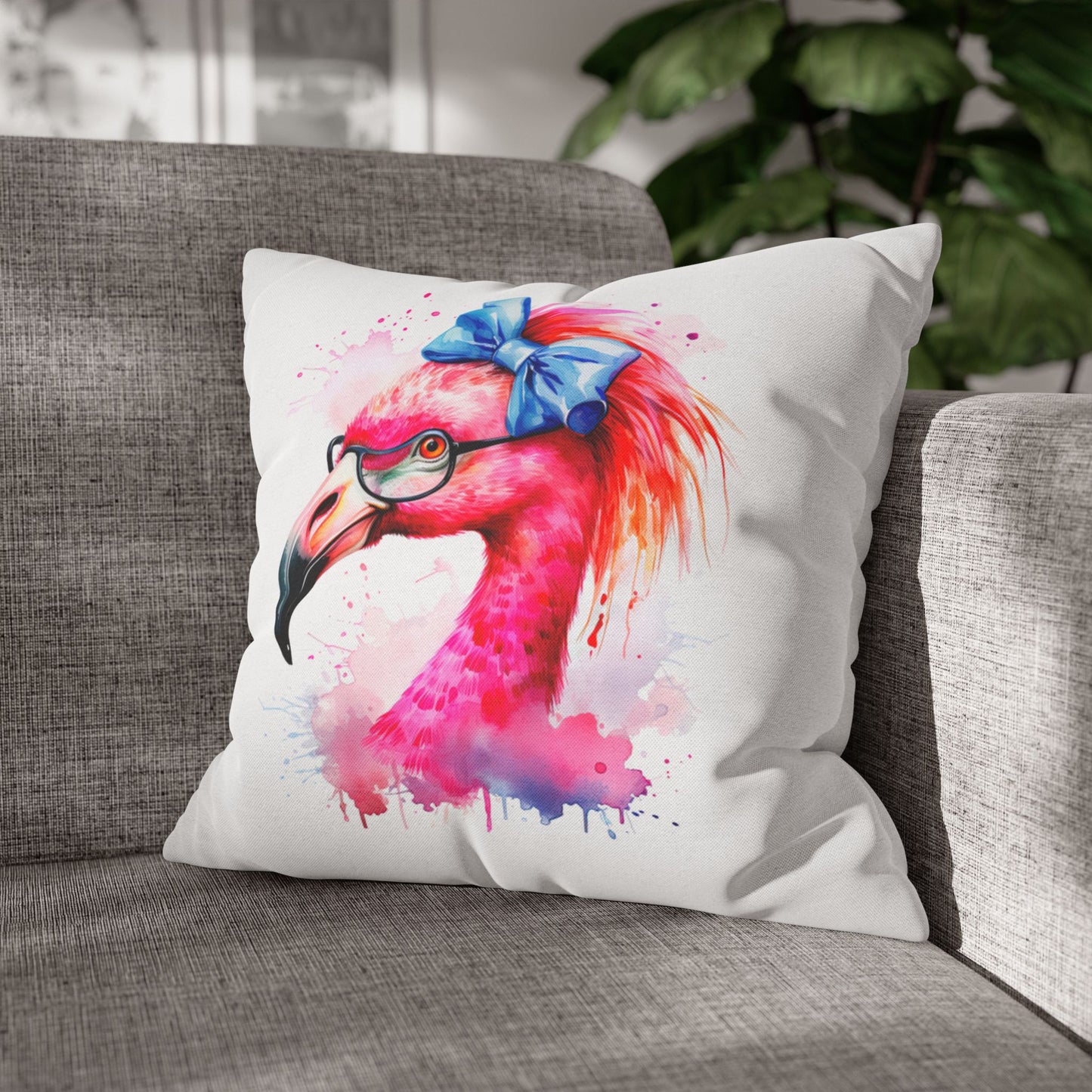 Decorative square pillowcase featuring a flamingo head wearing glasses and a big blue bow on a white background.