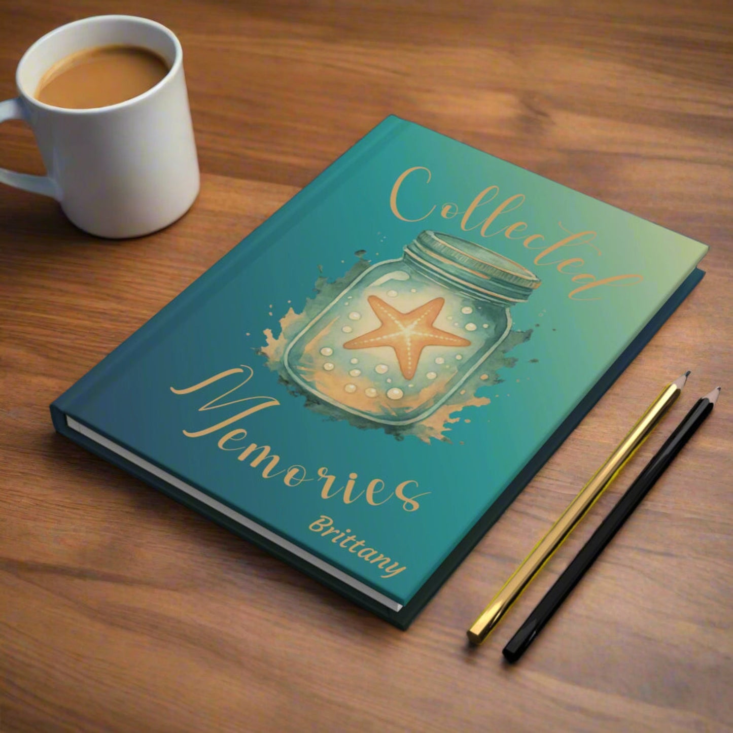 Journal with 'Collected Memories' design on a dark surface with stationery items.