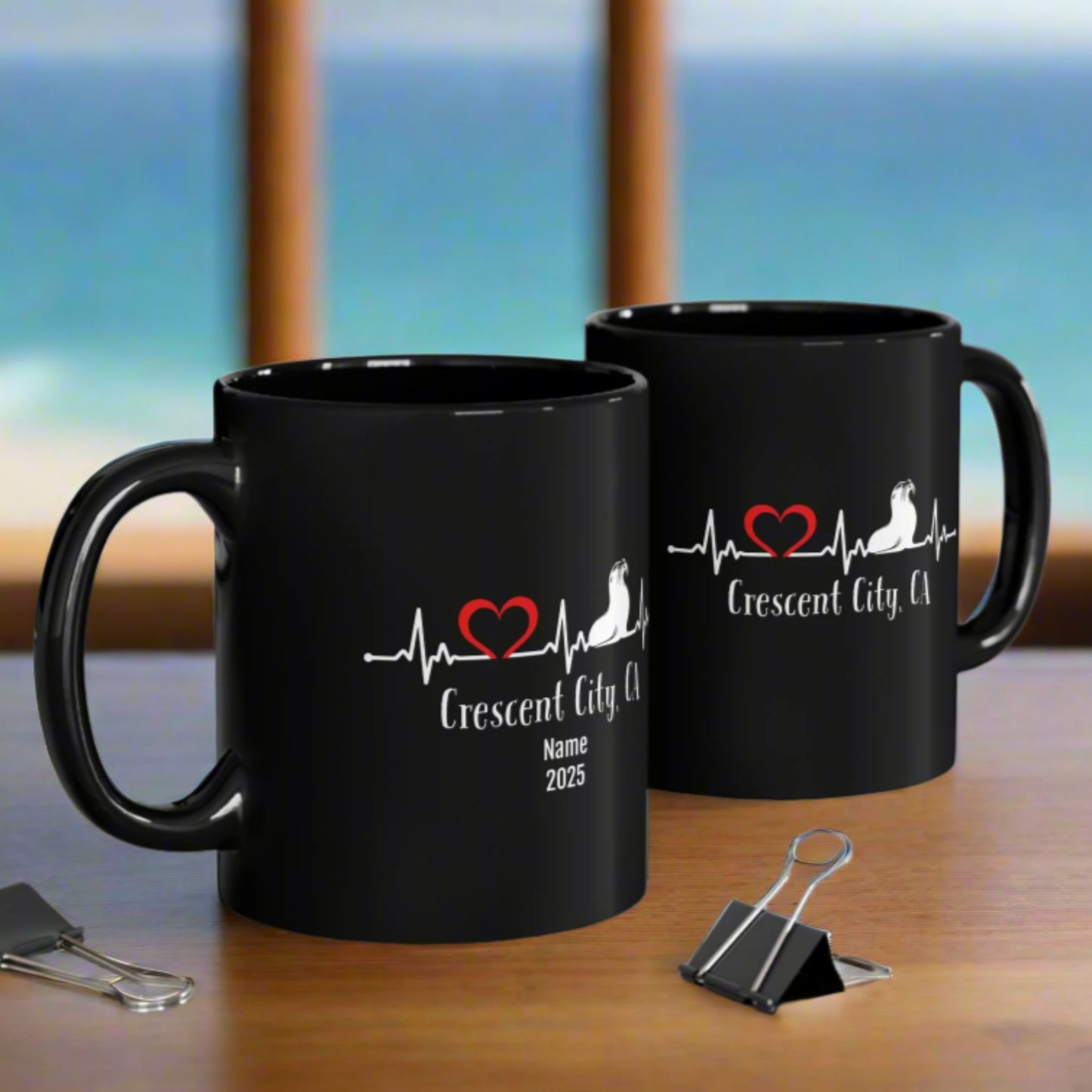 Two black mugs with personalized name and year with a heartline design with a seal and heart.