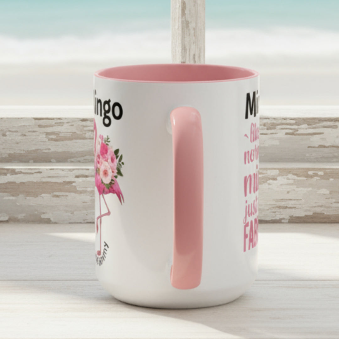White mug with pink interior and handle, featuring text and a floral design on a white background.