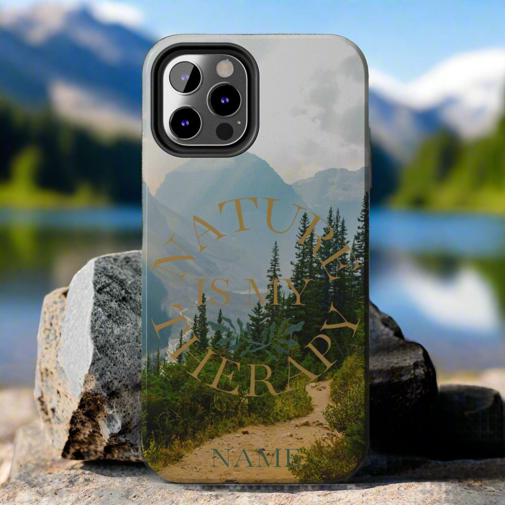 Phone case with nature design and text on a rock against a gray background