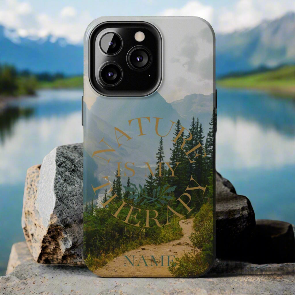 Phone case with nature design and 'Nature is my therapy' text on a gray background