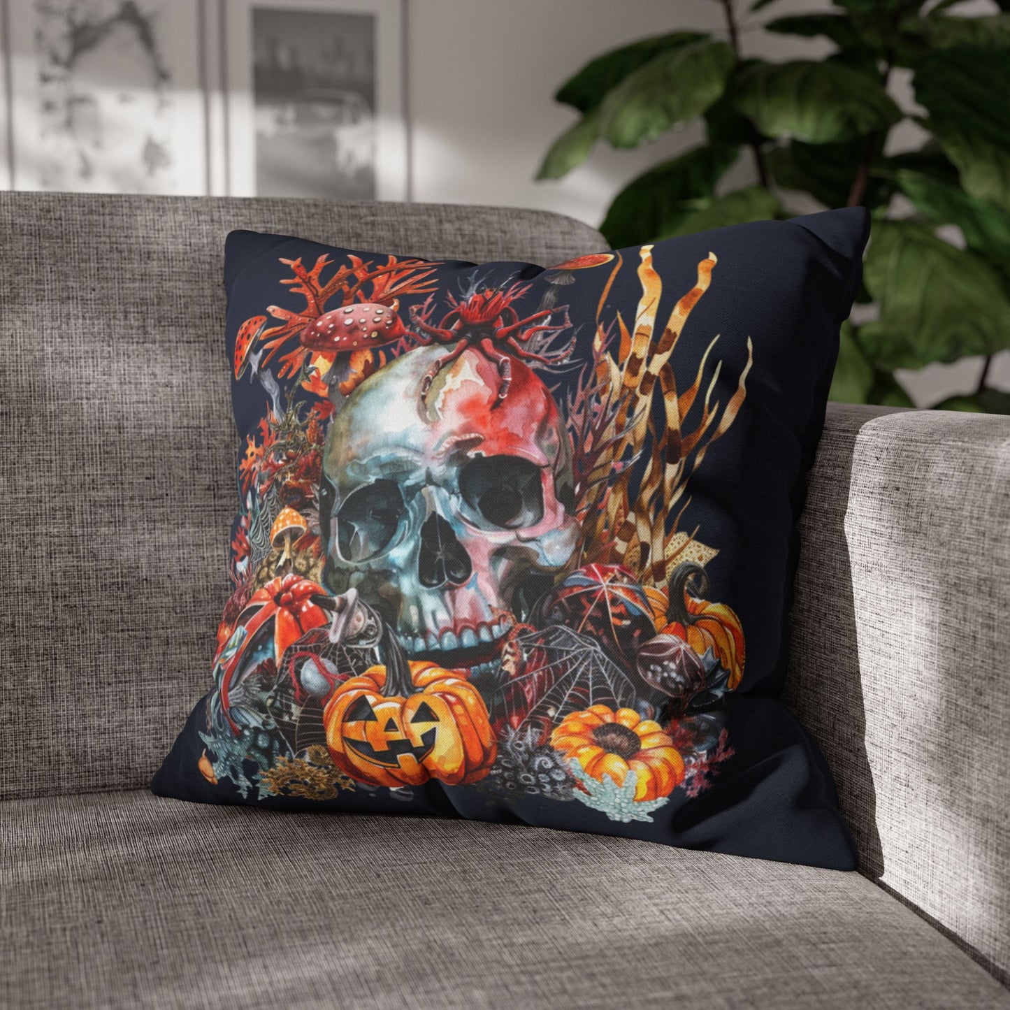 Decorative pillow with a skull and pumpkins design on a dark background.