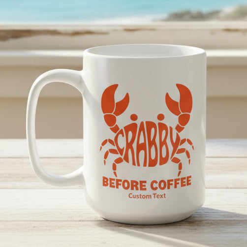 White mug with orange crab design and text Crabby Before Coffee and can be personalized.
