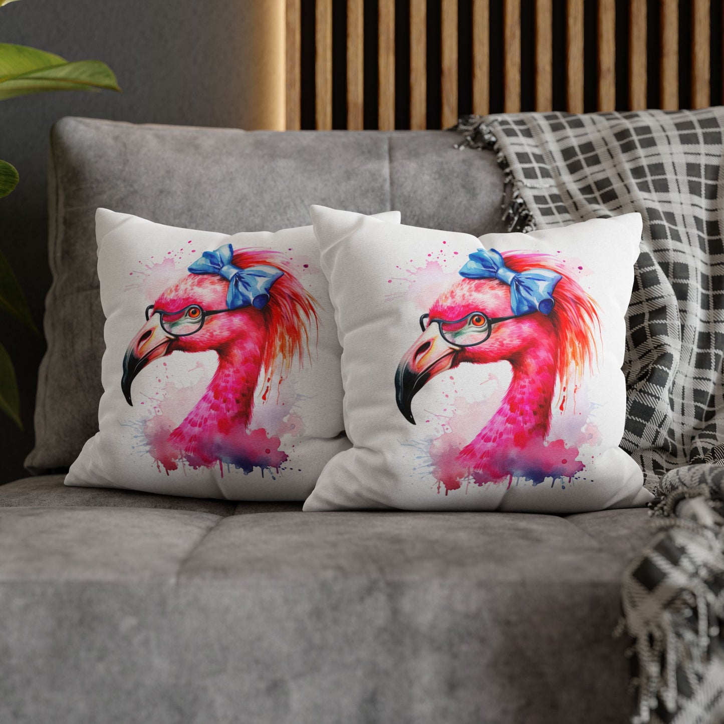 Two decorative square pillowcases featuring a flamingo head wearing glasses and a big blue bow on a white background showing double-sided printing.