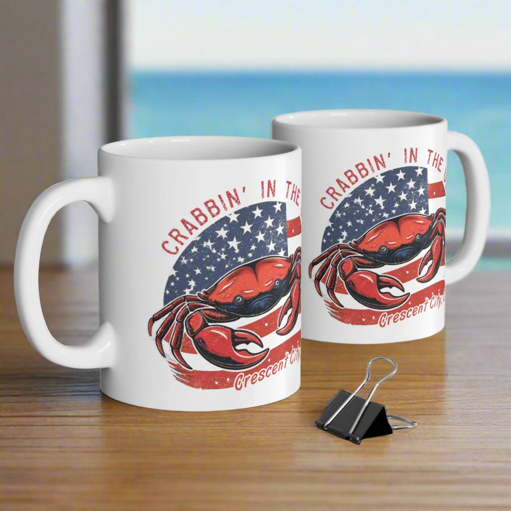 Two mugs with a crab design and text Crabbin' in the USA and Crescent City, CA.