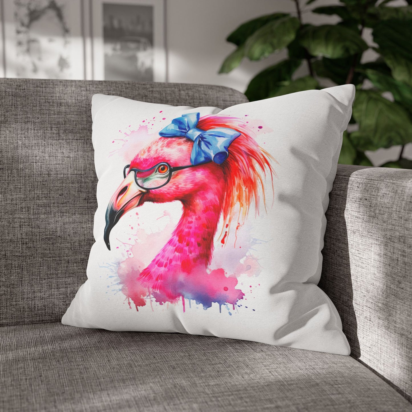 Decorative square pillowcase featuring a flamingo head wearing glasses and a big blue bow on a white background.