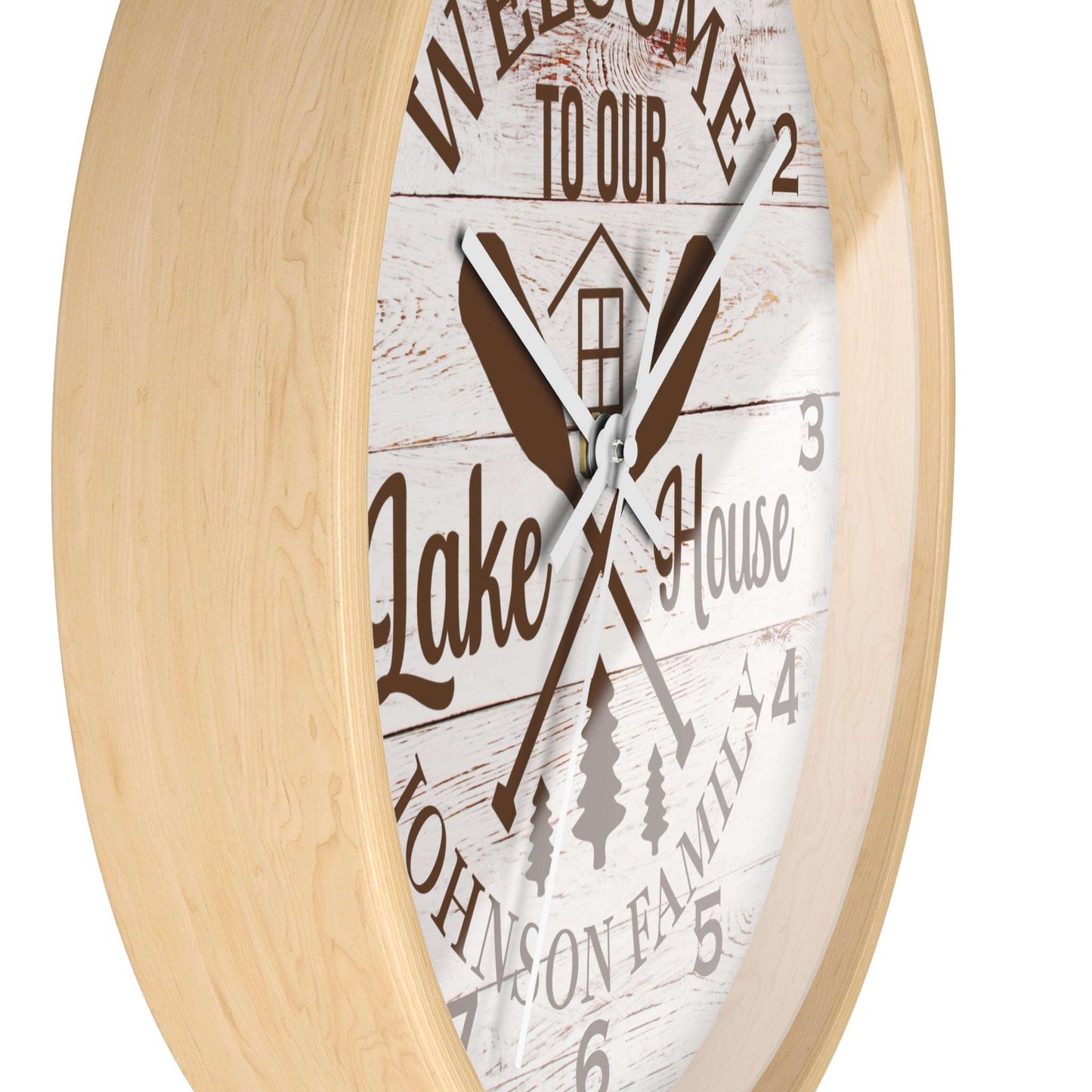 Wall clock with 'Welcome to our Lake House' text and wooden design on a white background