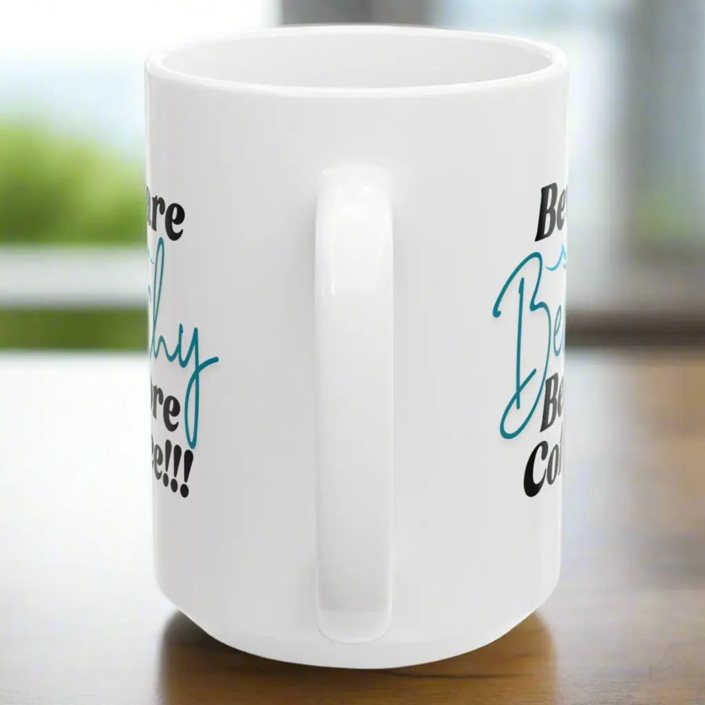 Side view of White 15 oz. coffee mug that says Beware Beachy Before coffee with wave image.