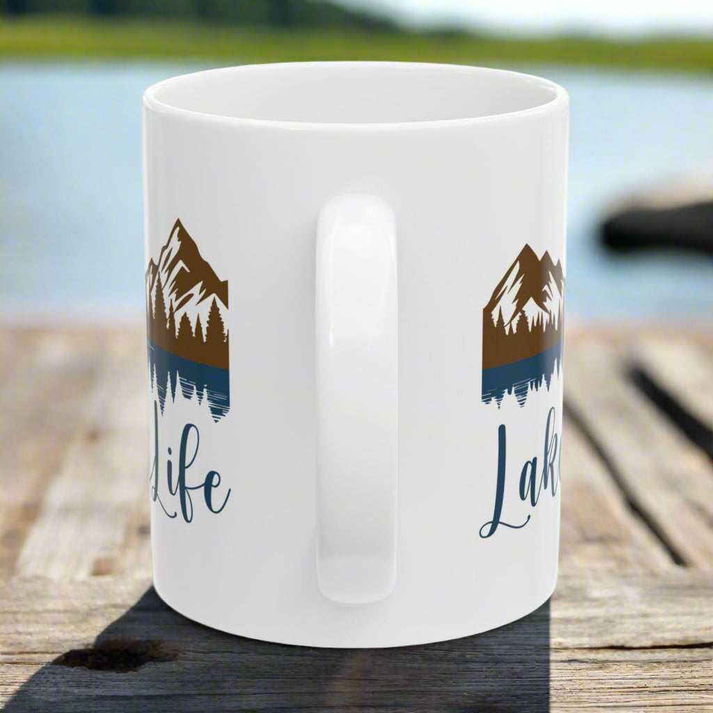 Handle side view of our white 11 oz. ceramic mug with mountain and lake reflection design, featuring the phrase “Lake Life” – perfect for nature lovers.