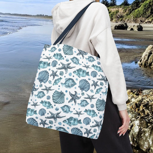 18" x 18" Tote bag with blue strap and an all-over blue seashell, starfish, and fish pattern on a white background with white handles.