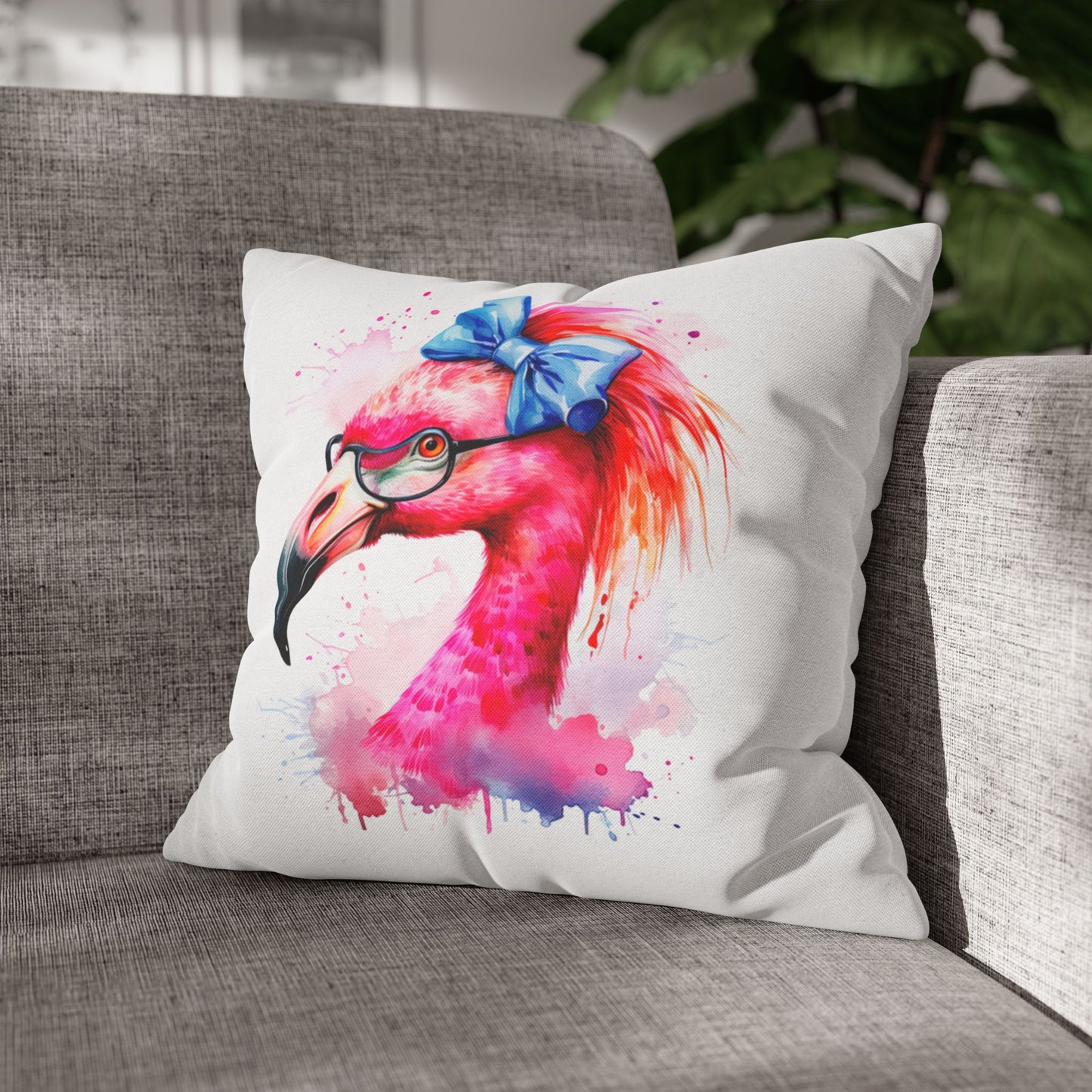 Decorative square pillowcase featuring a flamingo head wearing glasses and a big blue bow on a white background.
