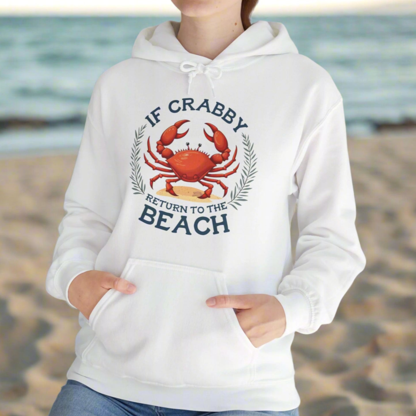 White hoodie with a crab graphic and text If Crabby Return to the Beach, worn by a person, against a neutral background.