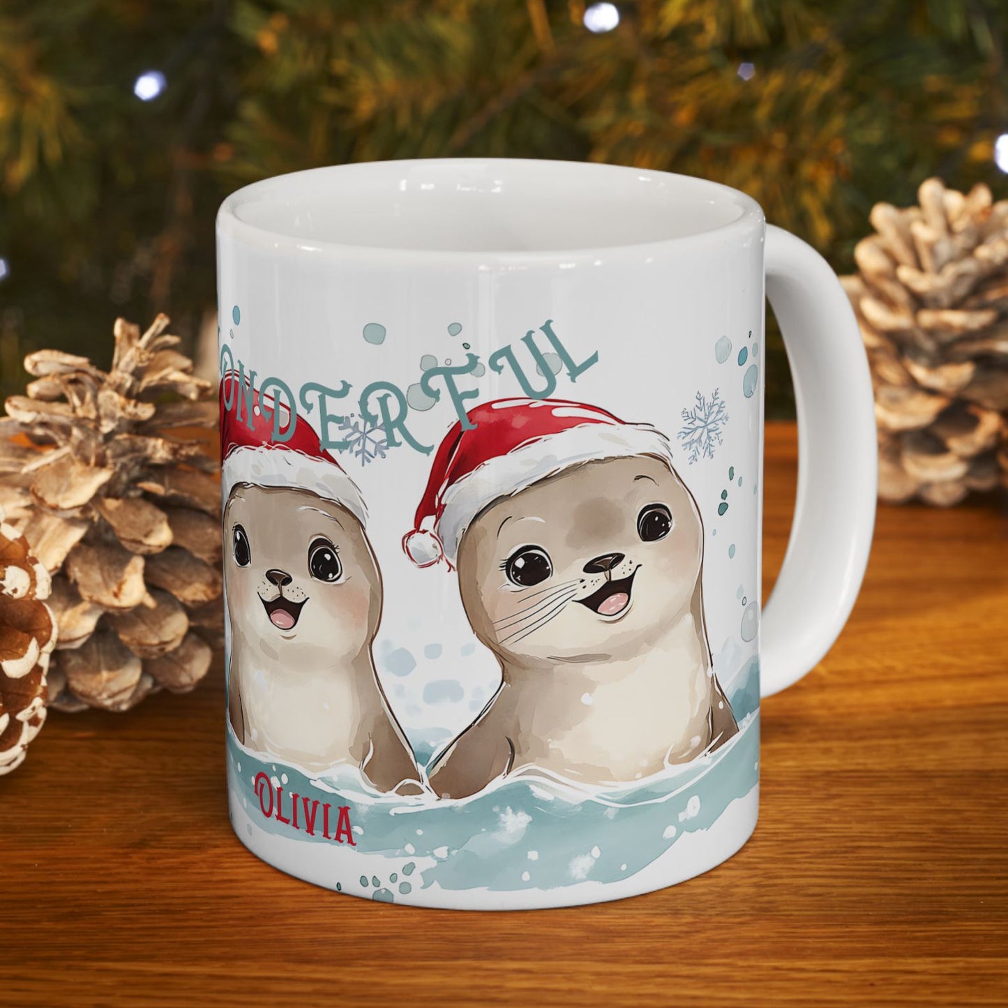 Mug with cartoon seals wearing Santa hats on a wooden surface with Christmas decorations.