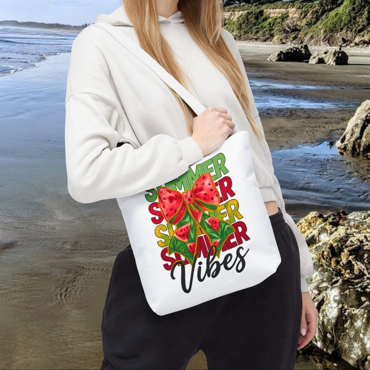 White 13" x 13" tote bag with the word "Summer" repeated in green, red, and yellow, featuring a coquette-style bow, watermelon illustrations, and the word "Vibes" underneath.