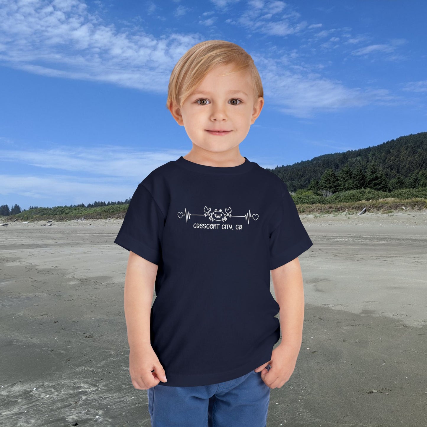 Navy Toddler t-shirt featuring a smiley crab on a heartbeat line with hearts at both ends and the text “Crescent City, CA” underneath.