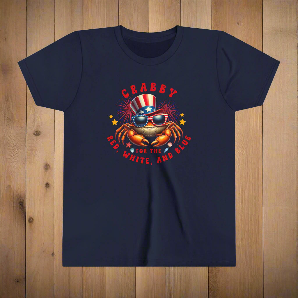Navy blue t-shirt with a crab graphic wearing sunglasses and an American flag hat, text 'CRABBY FOR THE RED, WHITE, AND BLUE' on a white background.
