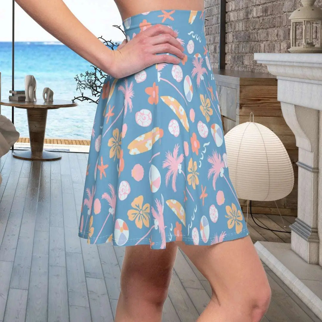 Beach Paradise Skater Skirt with tropical images in fun soft colors of surfboards, palm trees, hibiscus flowers, starfish and waves on a light blue background.