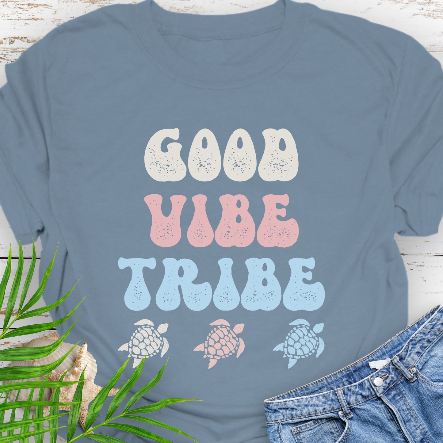 Blue t-shirt with 'Good Vibe Tribe' text and sea turtle graphics.