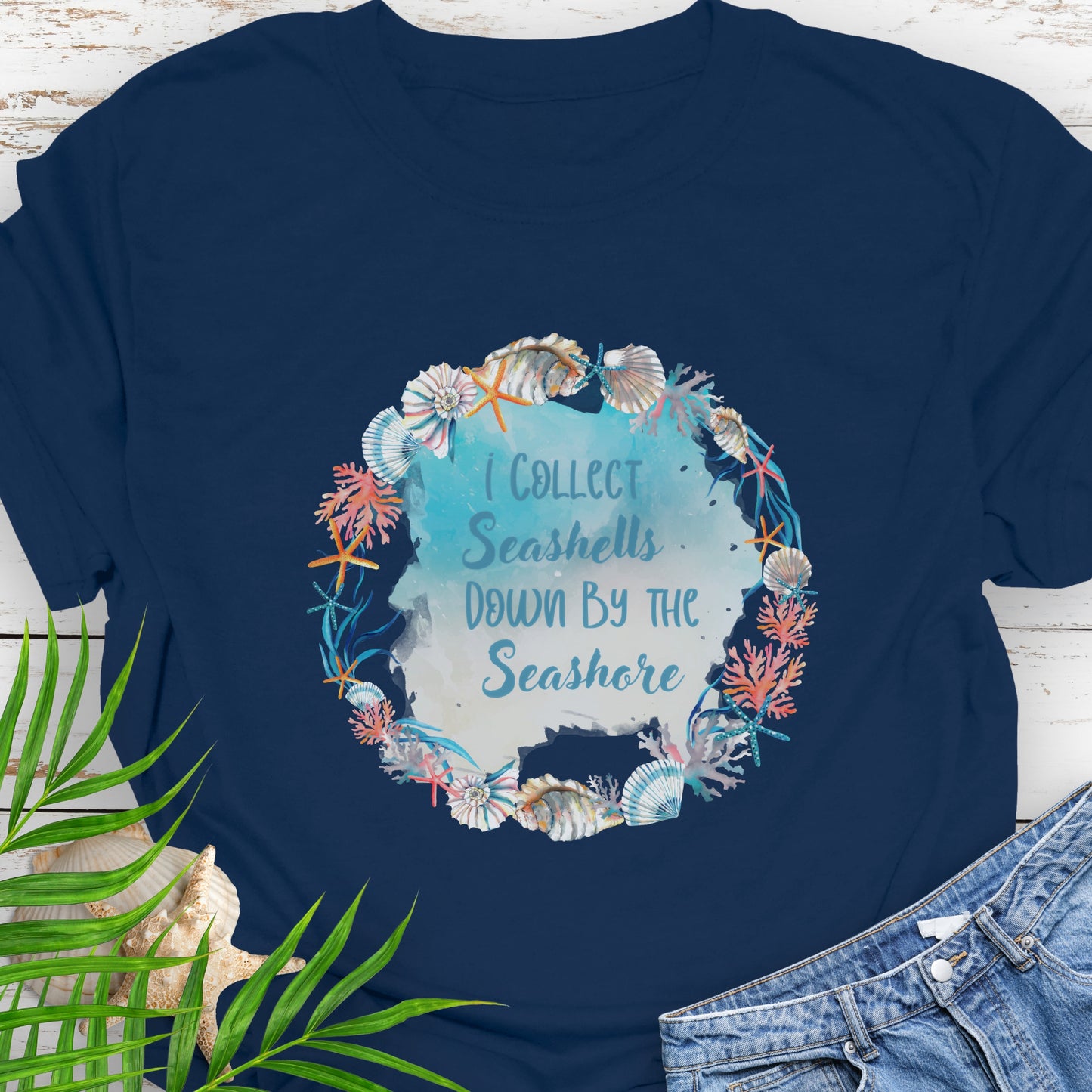Navy blue t-shirt with seashell design with text I Collect Seashells down by the Seashore.