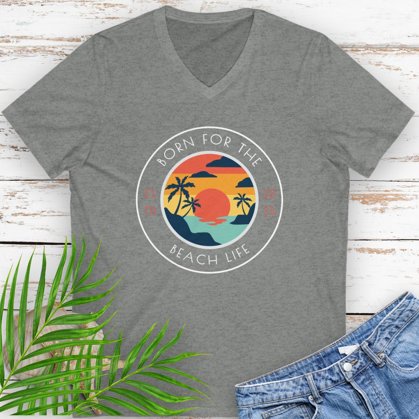 Gray v-neck t-shirt with circle design with a beach scene and the text “Born for the Beach Life.