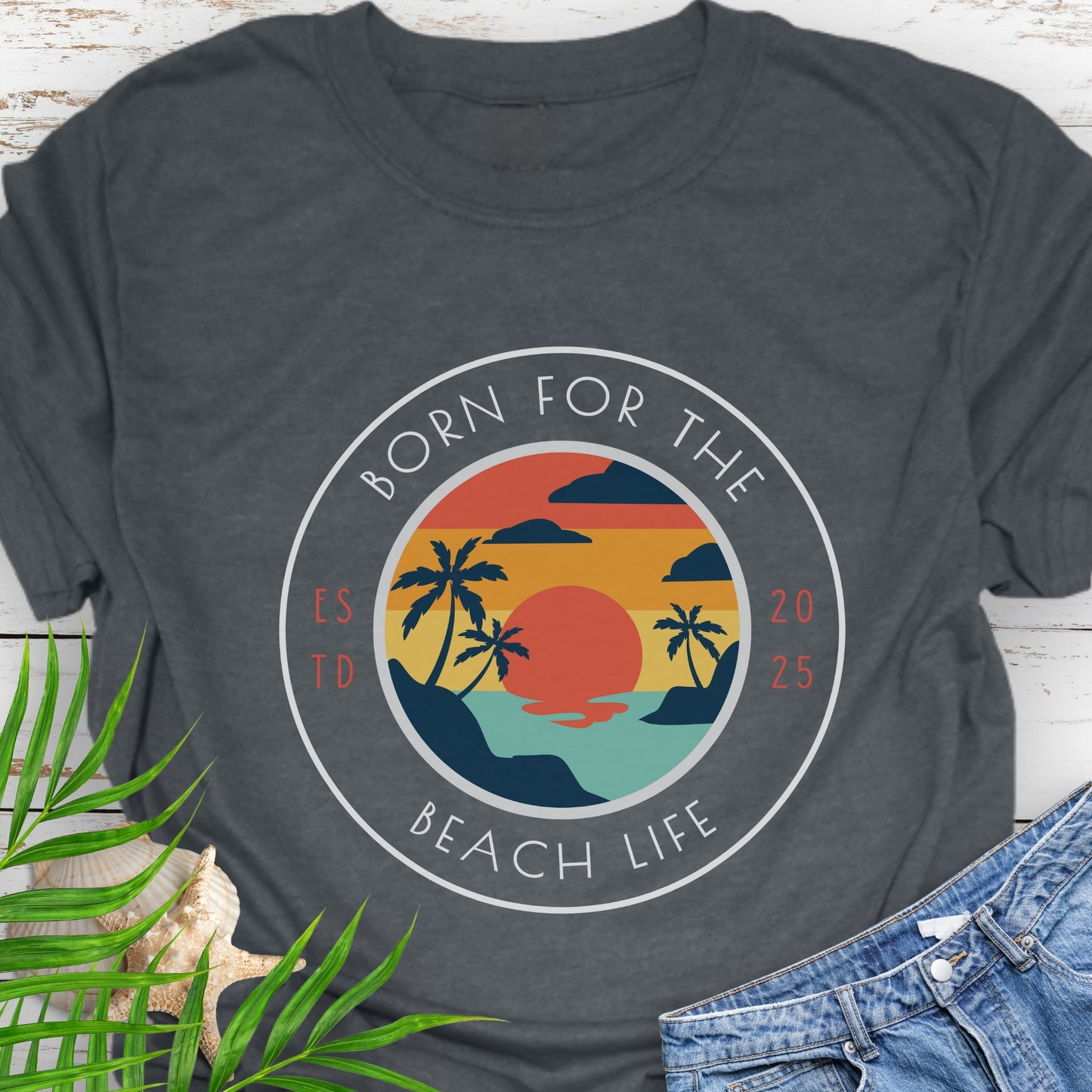 Gray t-shirt with circle design with a beach scene and the text “Born for the Beach Life.
