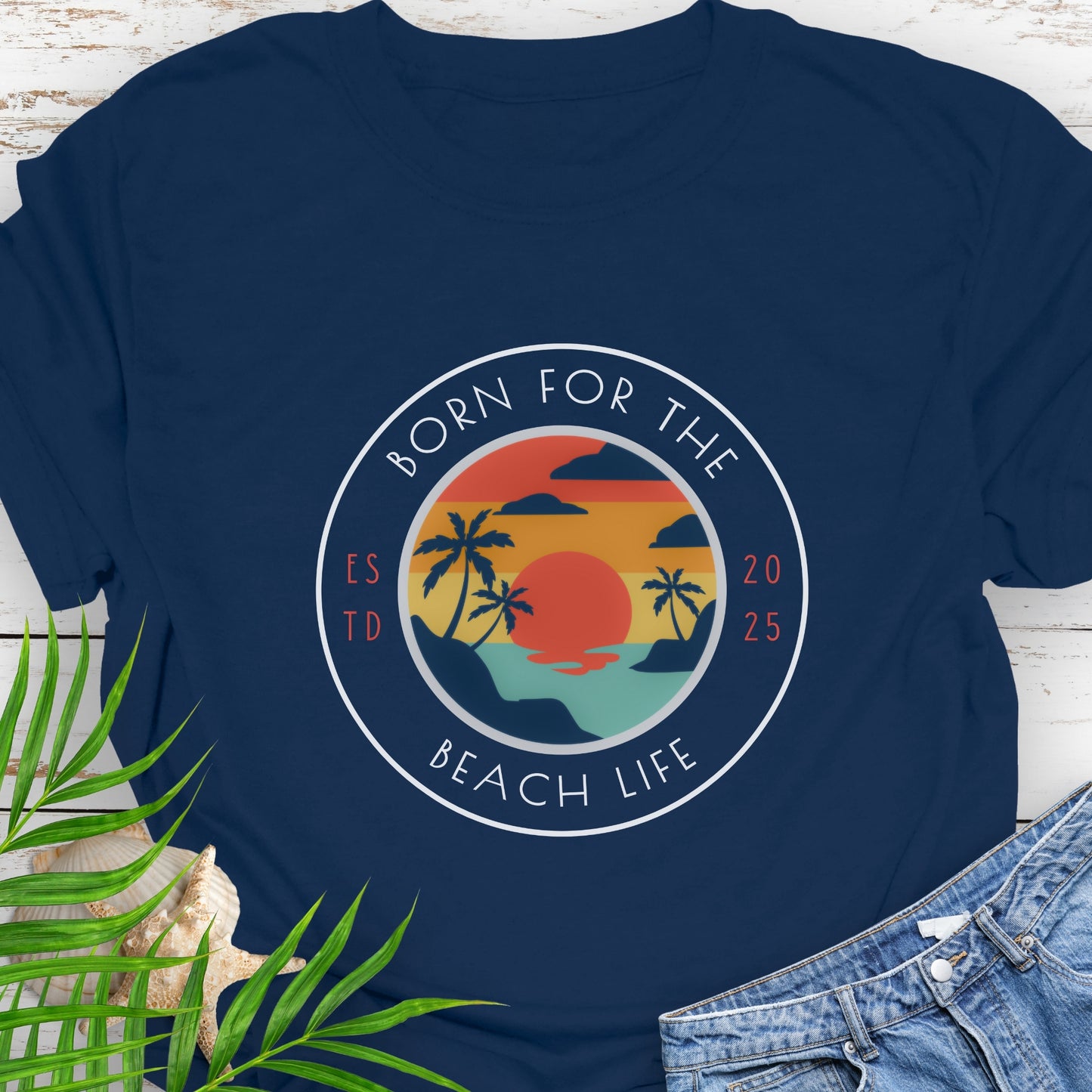 Navy blue t-shirt with circle design with a beach scene and the text “Born for the Beach Life.