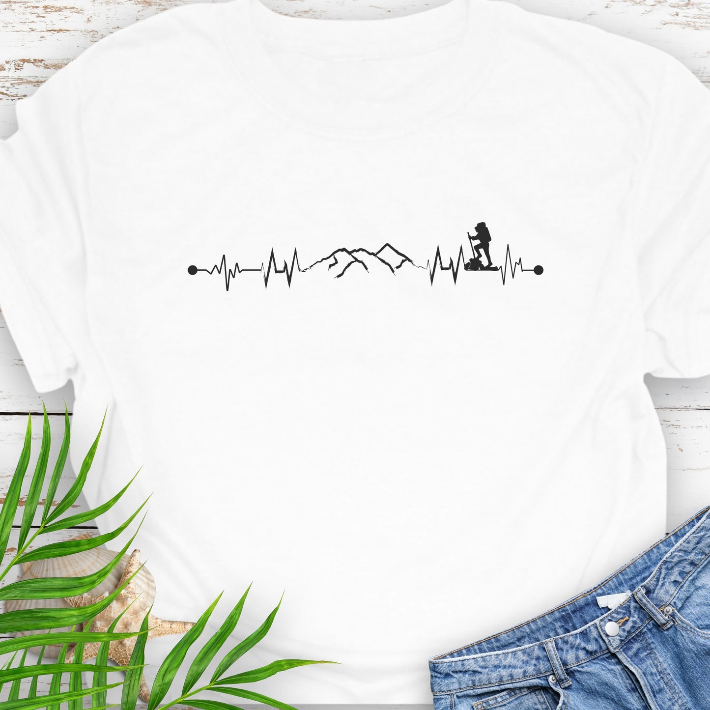 White t-shirt with a heartbeat line with a mountain range and backpacker.