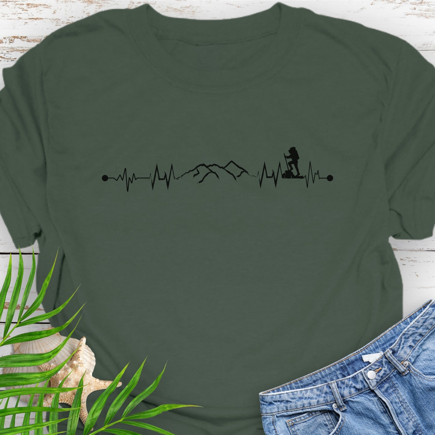 Green t-shirt with a heartbeat line with a mountain range and backpacker.