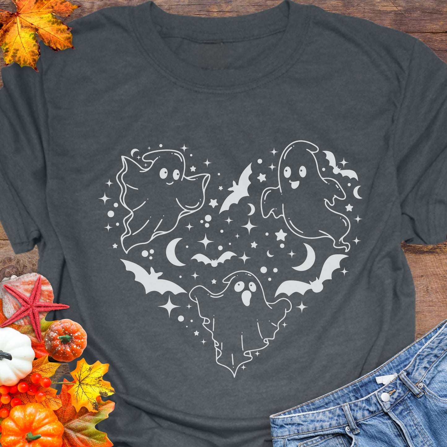 Dark gray unisex T-shirt with a design of white ghosts and black bats forming the shape of a heart.