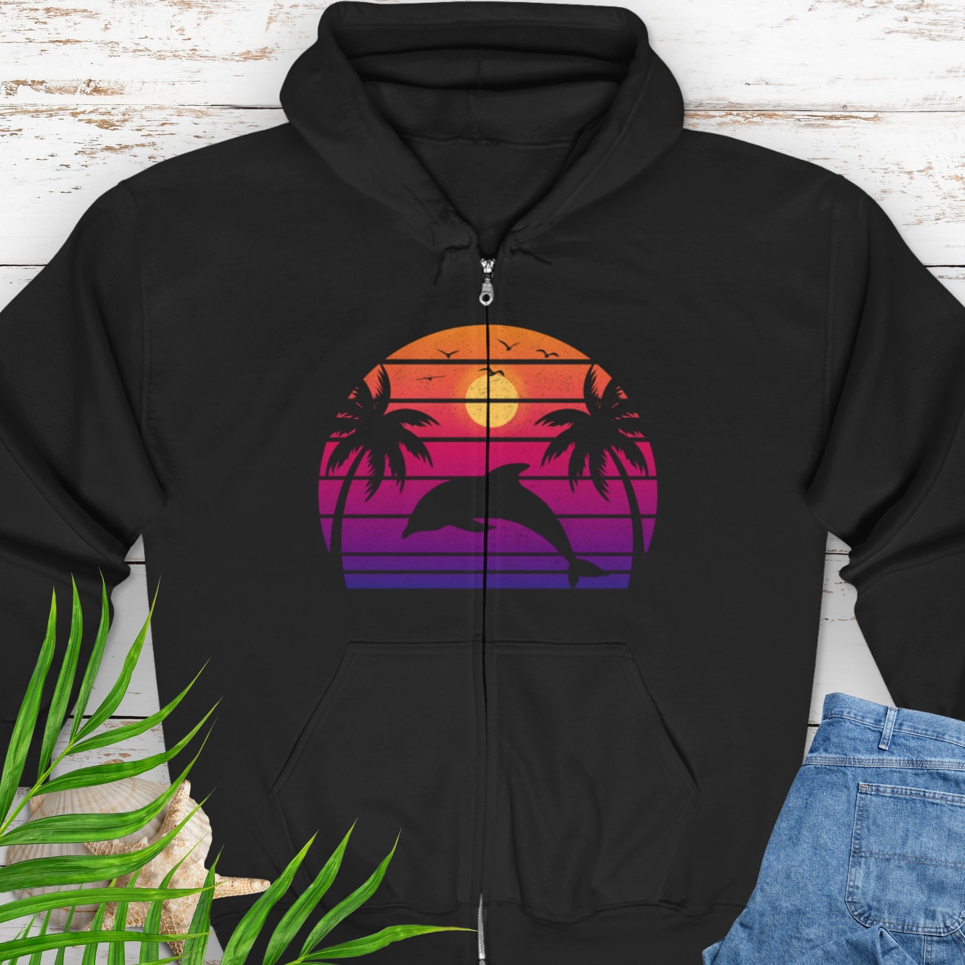 Black zipped hooded sweatshirt with a retro sunset dolphin graphic.