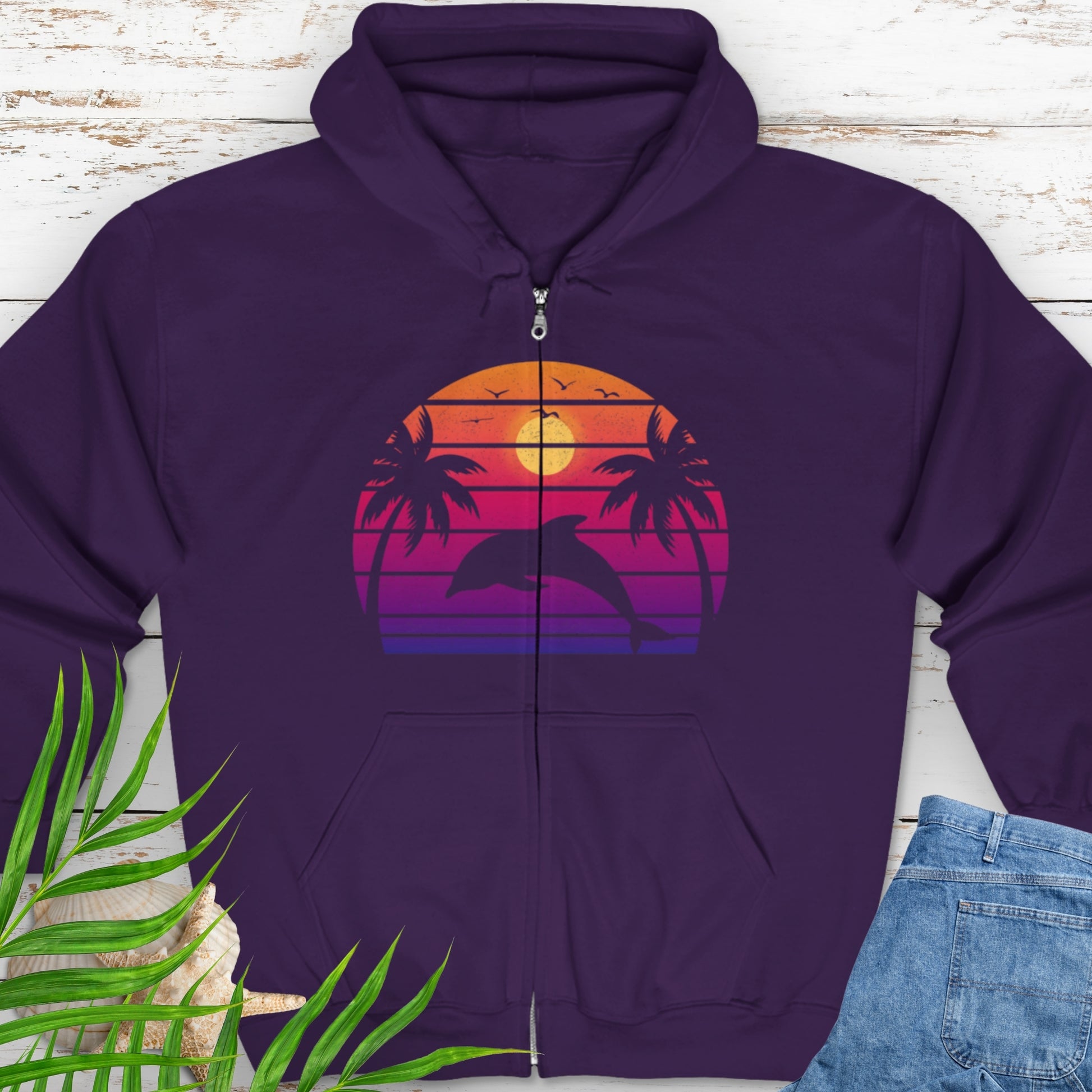 Purple zipped hooded sweatshirt with a retro sunset dolphin graphic.