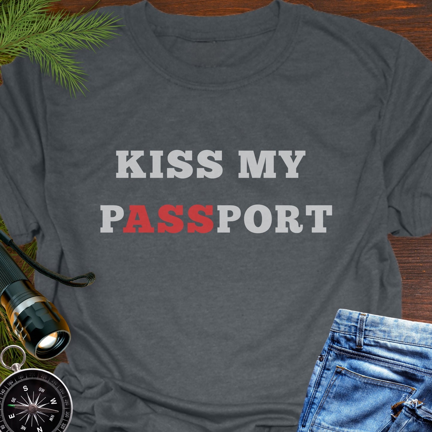 Gray t-shirt with the phrase “Kiss My Passport” where the letters “ASS” are highlighted.