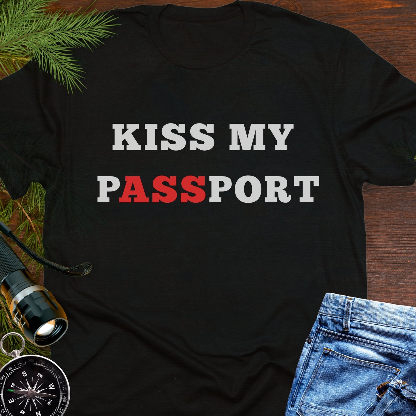 Black t-shirt with the phrase “Kiss My Passport” where the letters “ASS” are highlighted.