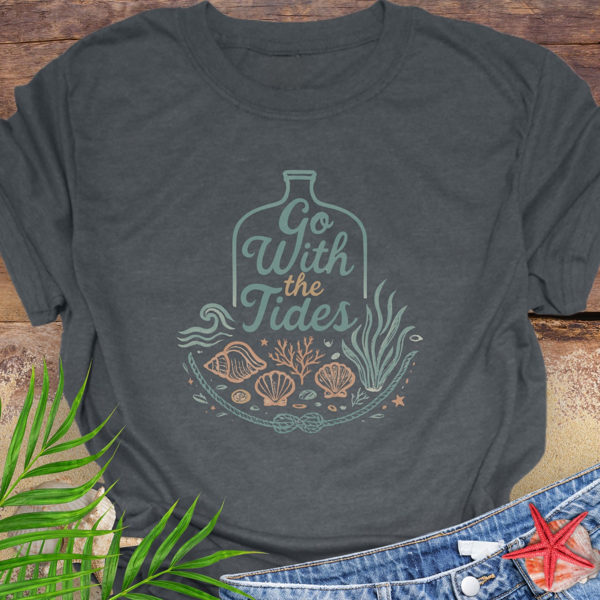 Dark gray Go With the Tides t-shirt with ocean bottle design, seashells, and coral artwork.