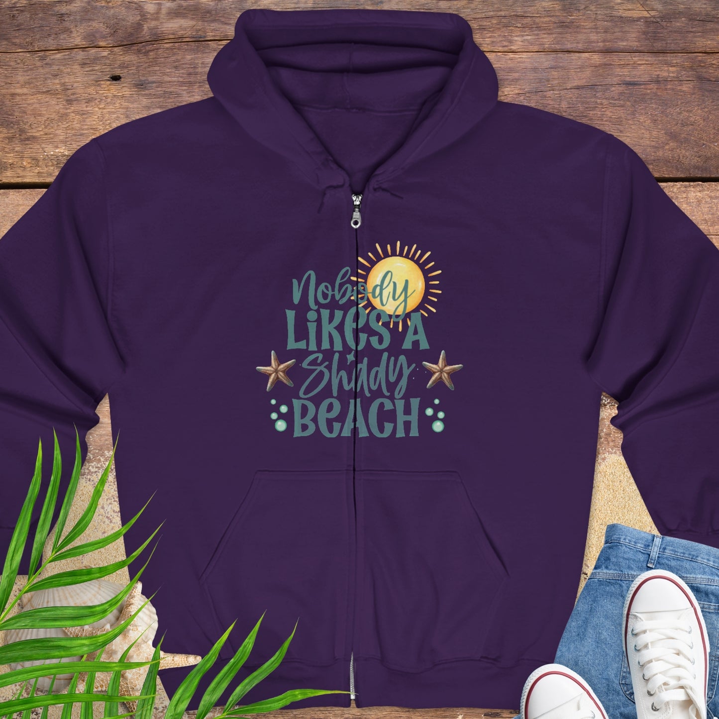 Purple hoodie with beach-themed graphics and text Nobody Likes a Shady Beach.