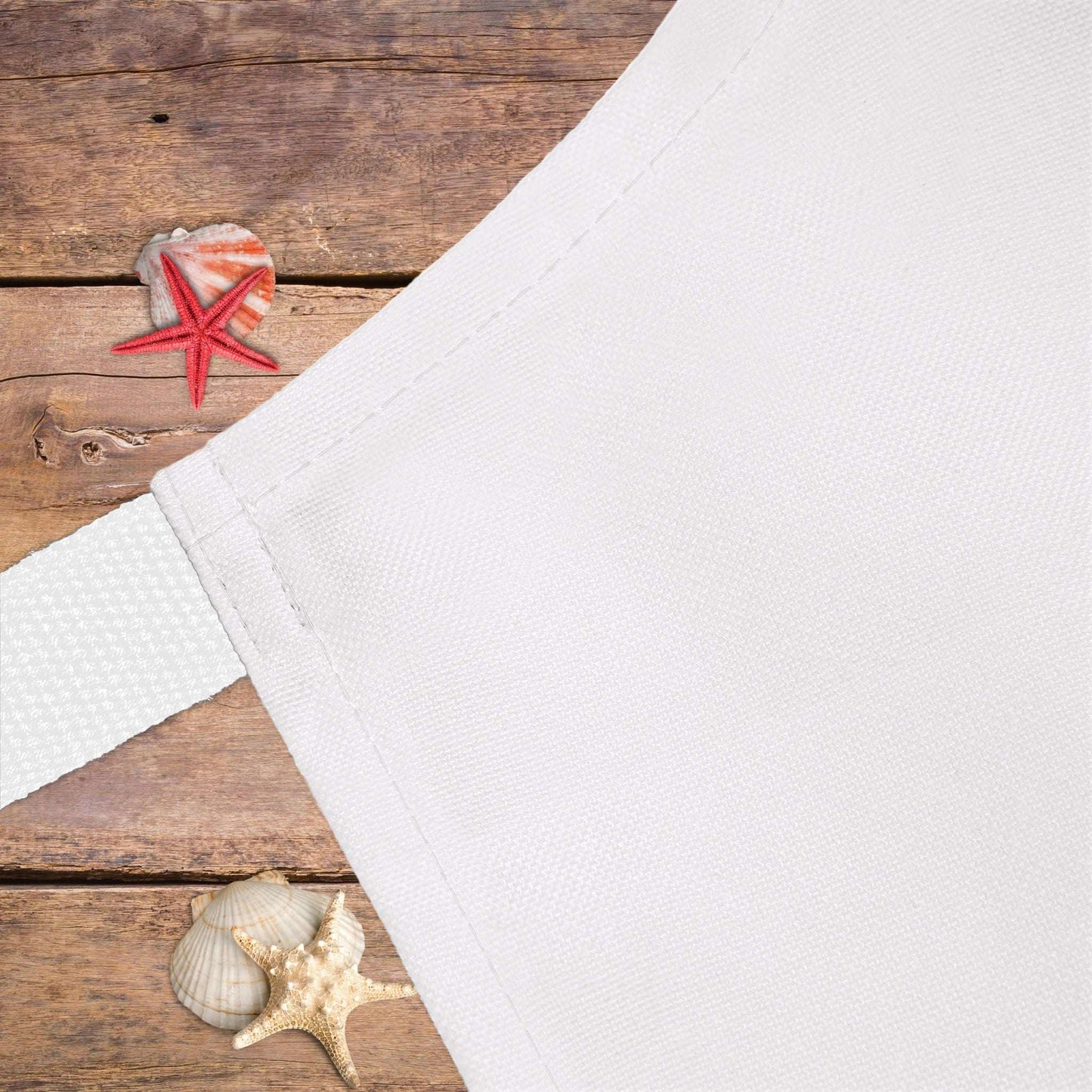 Close up of white apron with white strap.