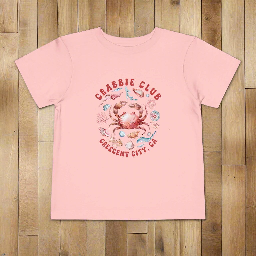 Pink Toddler t-shirt with the phrase “Crabbie Club Crescent City, CA” and a playful cartoon crab graphic.