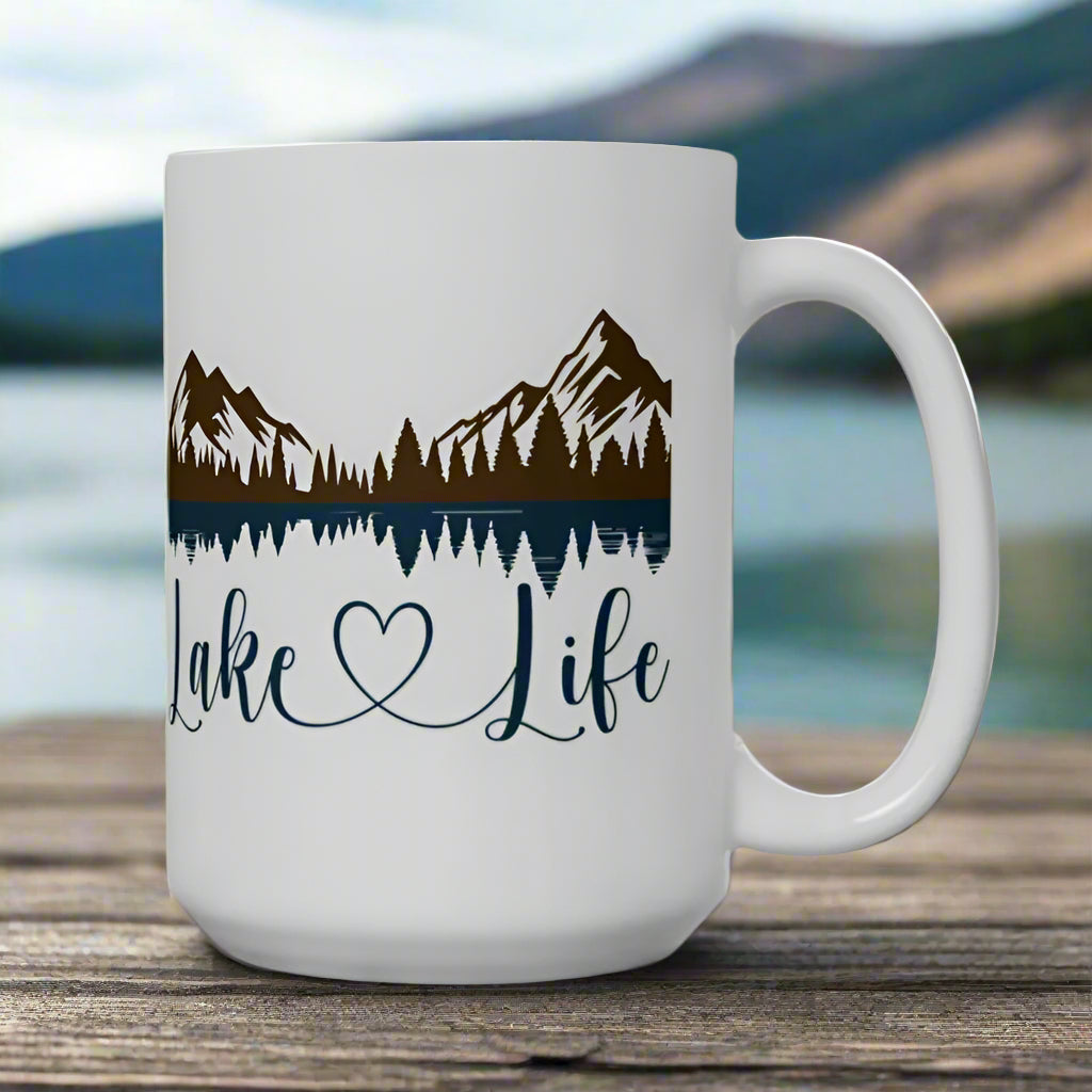 White 15 oz. ceramic mug with mountain and lake reflection design, featuring the phrase “Lake Life” – perfect for nature lovers.